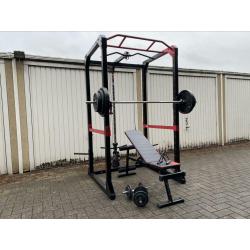 120kg + Powerrack en verstelbaar bankje + dumbells